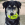 Black and white dog with green KONG Squeaker toy in its mouth.
